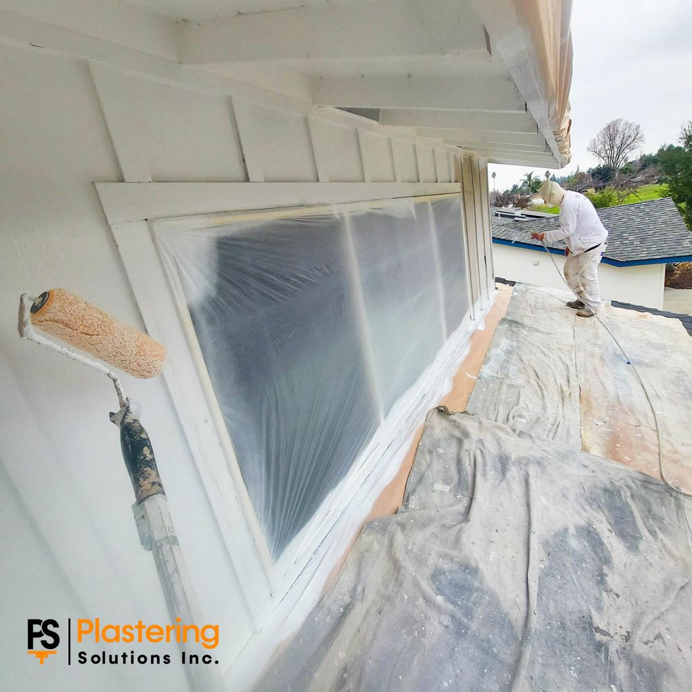 Masked windows and protected surfaces during exterior house painting work in San Jose