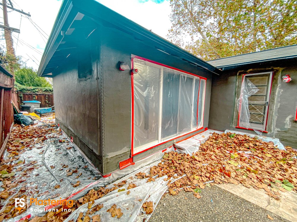 Brown coat applied around a masked sliding door at the back of the home