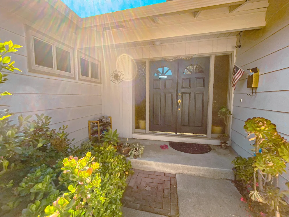 Front entry surrounded by old siding before the stucco conversion
