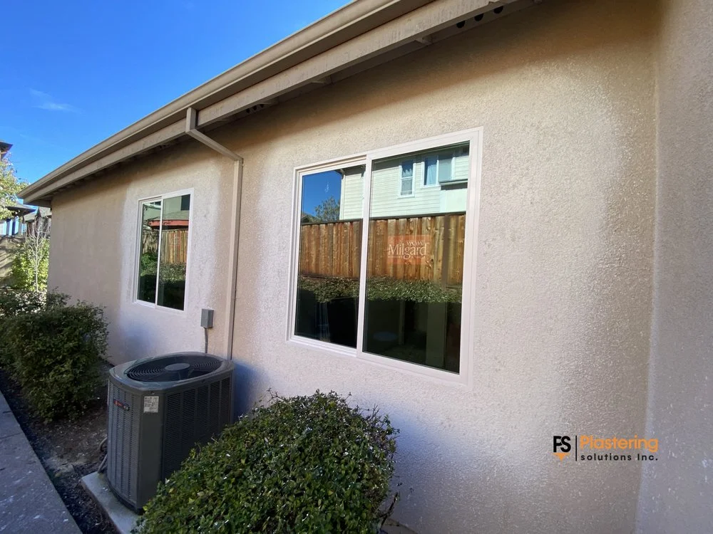 Completed side wall with new windows and matched stucco texture