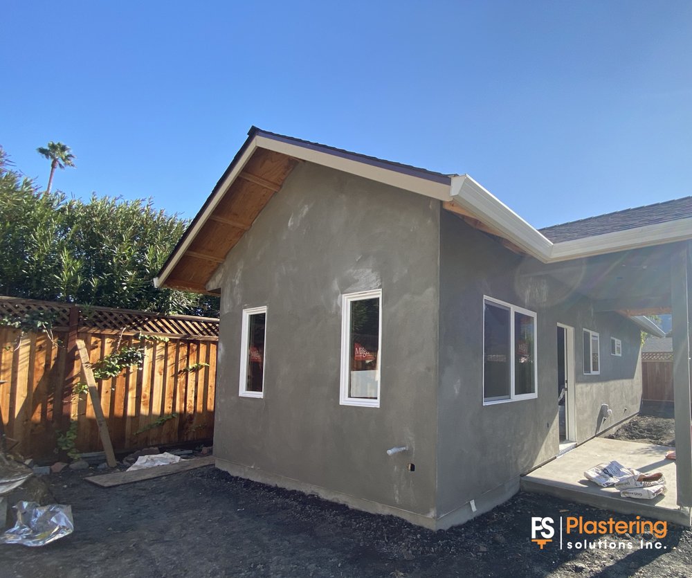 Finished two coat stucco on the new structure with white windows installed