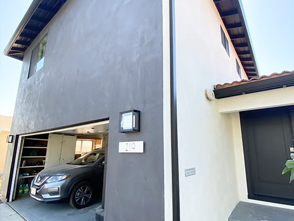 Dark and white smooth stucco finish at the garage and front entry
