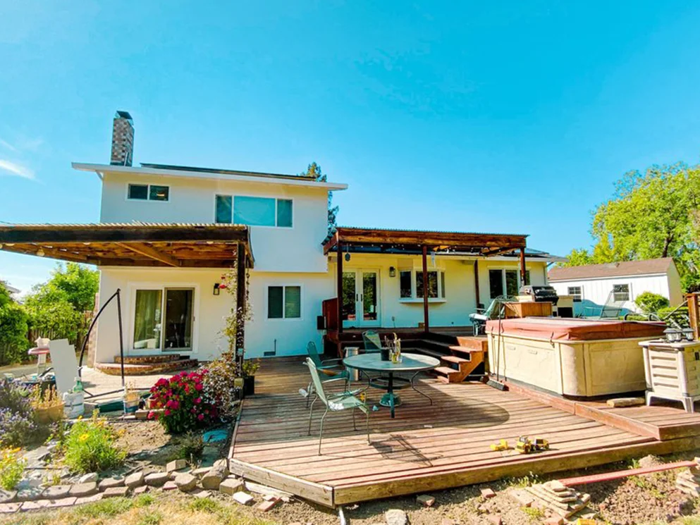 Back of the home with finished smooth acrylic stucco behind the deck