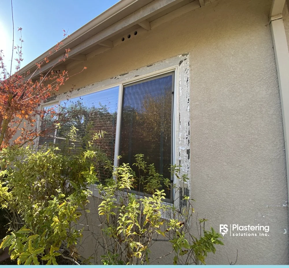 Replacement window with the stucco patch primed and ready for finish