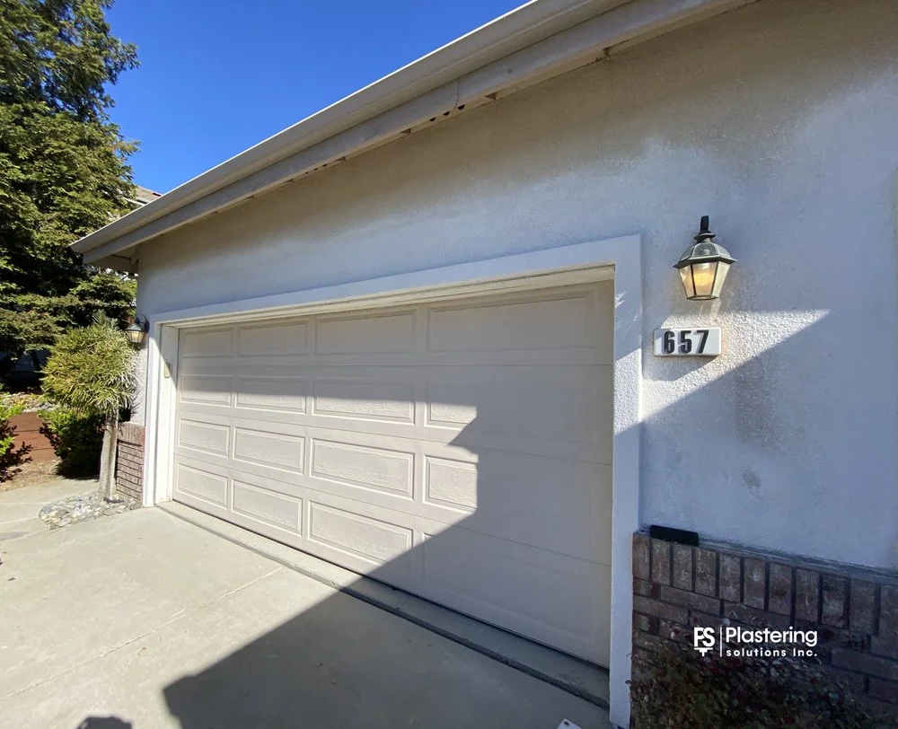 Garage wall with finished stucco matching the existing texture