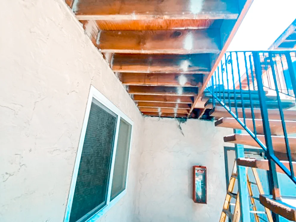 Damaged walkway ceiling framing removed during repair