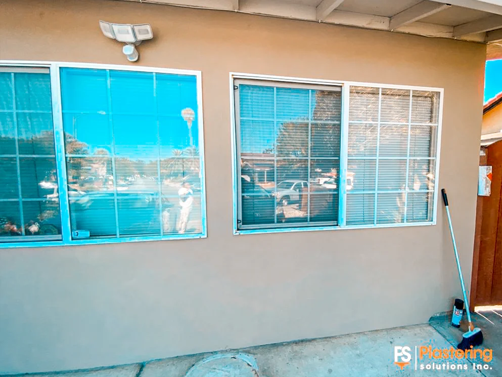 Front windows set in the completed smooth acrylic stucco wall