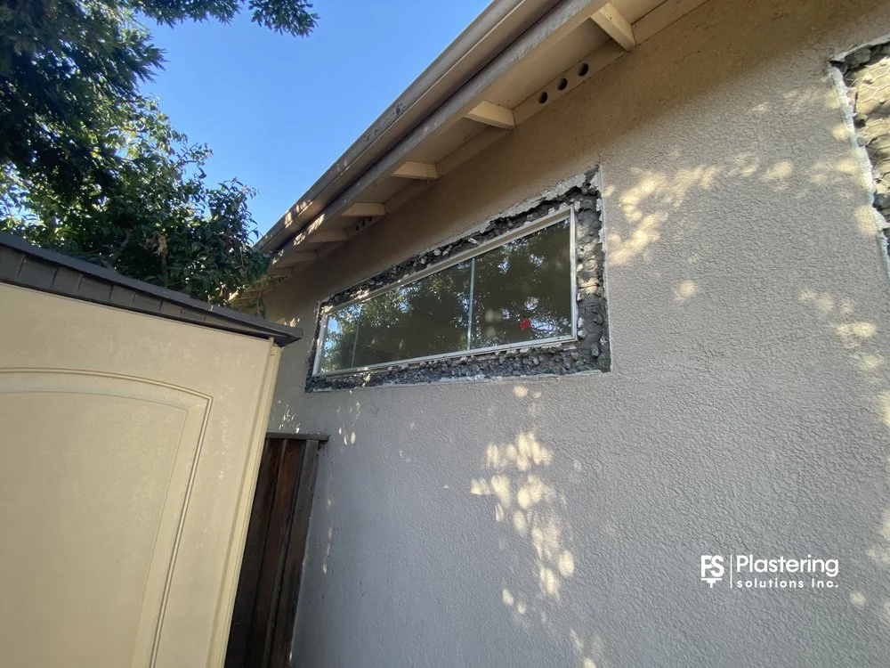 Narrow window with the surrounding stucco cut back for patch work