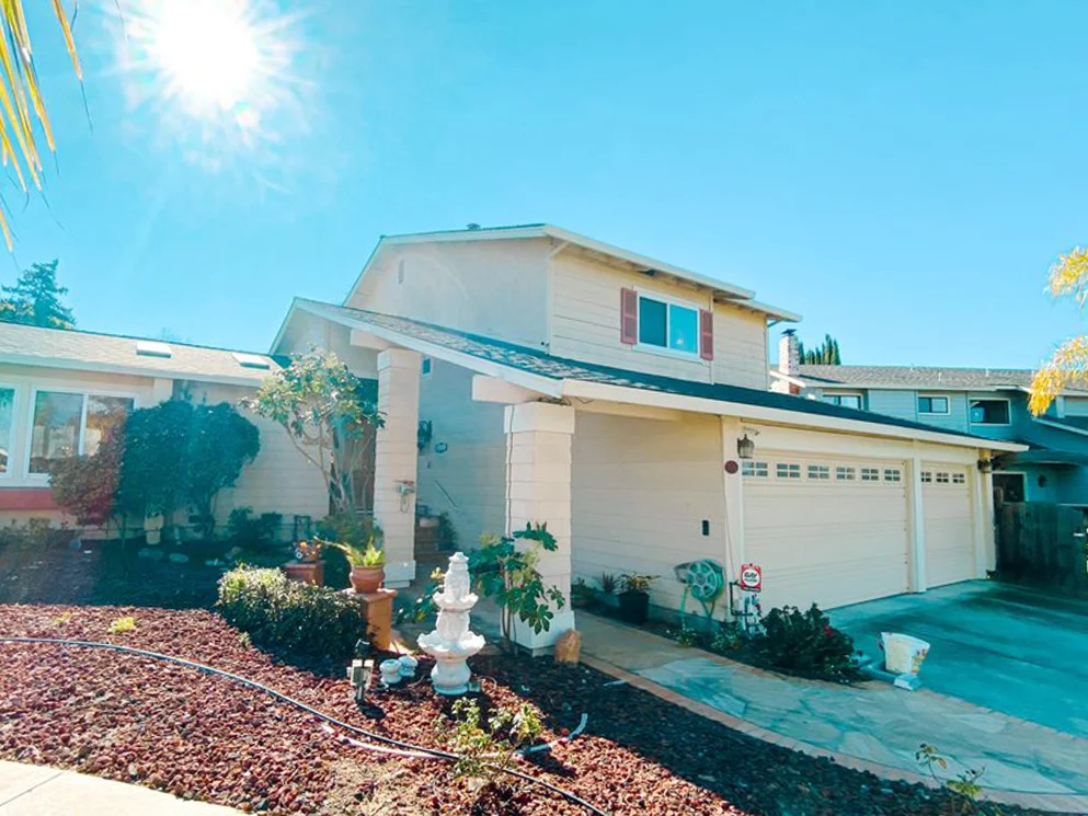 Front of a two story home after stucco resurfacing with a smooth acrylic finish