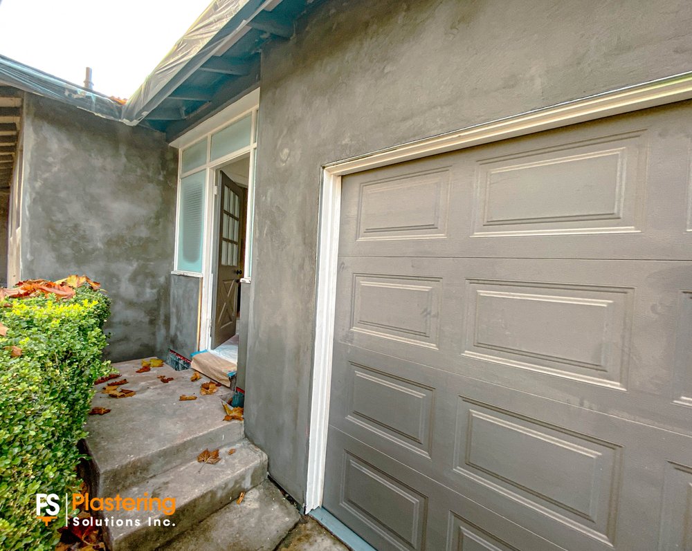 Brown coat around the entry and garage door before the color coat