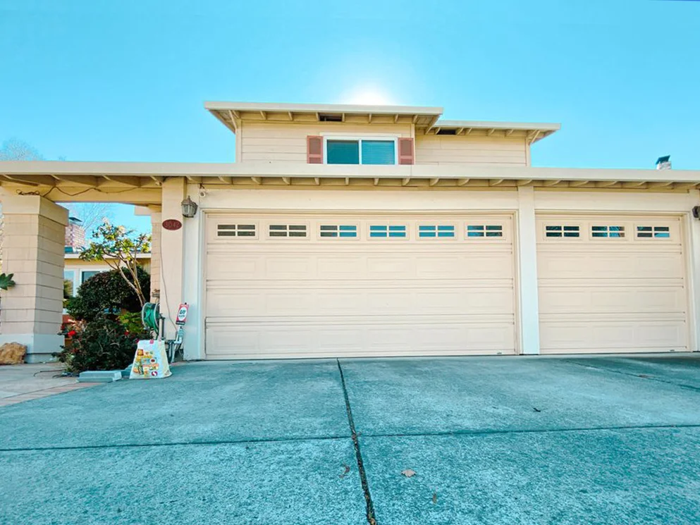 Resurfaced stucco front elevation with a three car garage