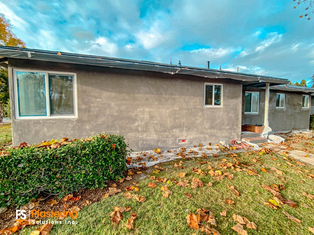 Side of the home with the brown coat complete across the wall