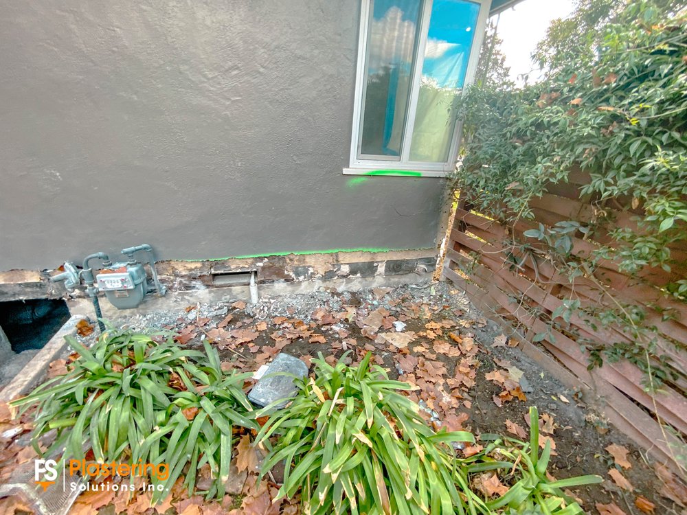 Lower wall opened along the foundation near the gas meter before new stucco