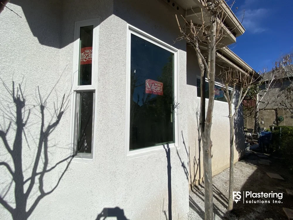 New corner windows surrounded by matched stucco texture