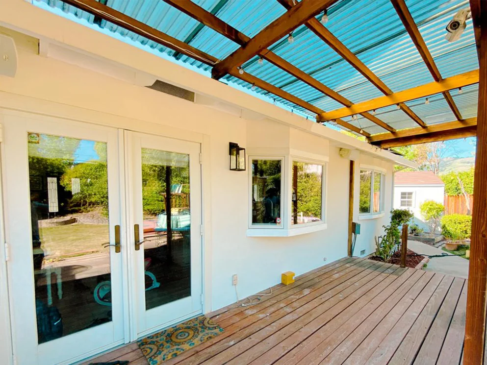 Completed smooth acrylic stucco along the covered patio with French doors