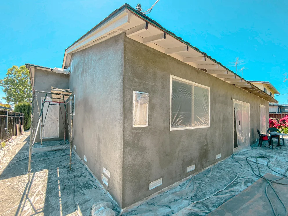 Brown coat applied on the back corner of the home