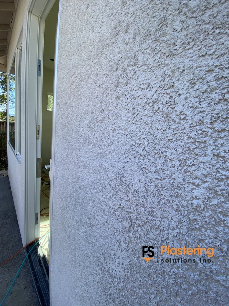 Close view of the matched stucco texture beside a new door