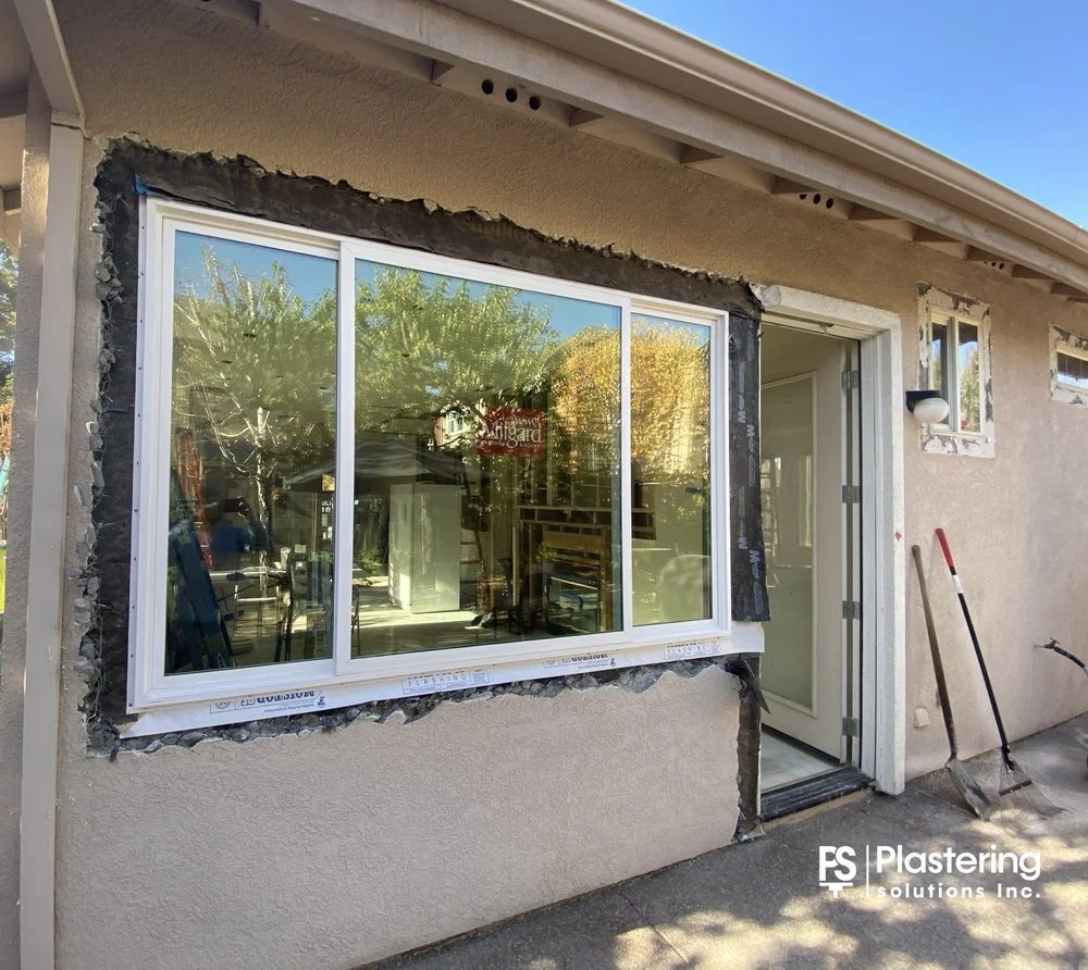 Large sliding window with building paper and lath around the new frame