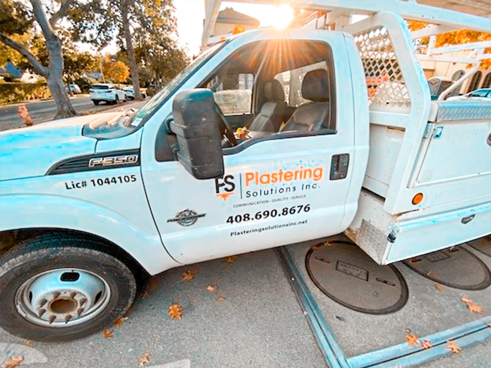 Plastering Solutions truck at the apartment job site