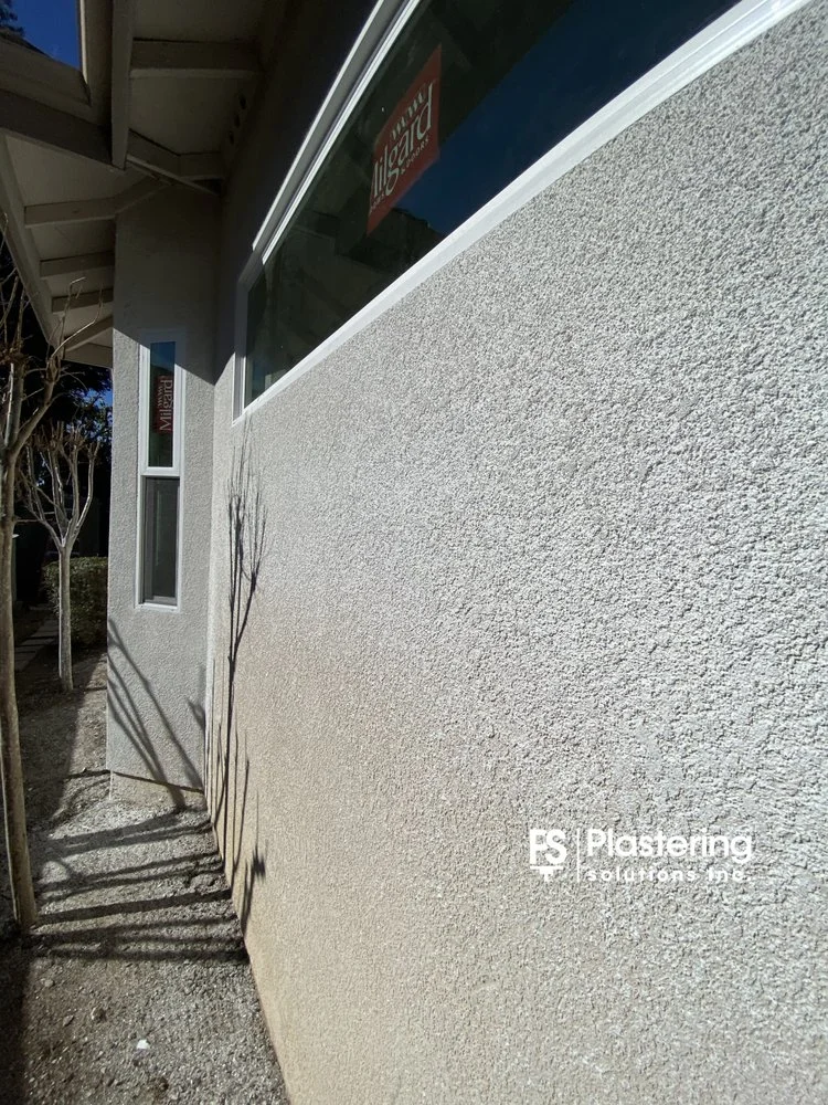 Close view of matched stucco texture below a new window