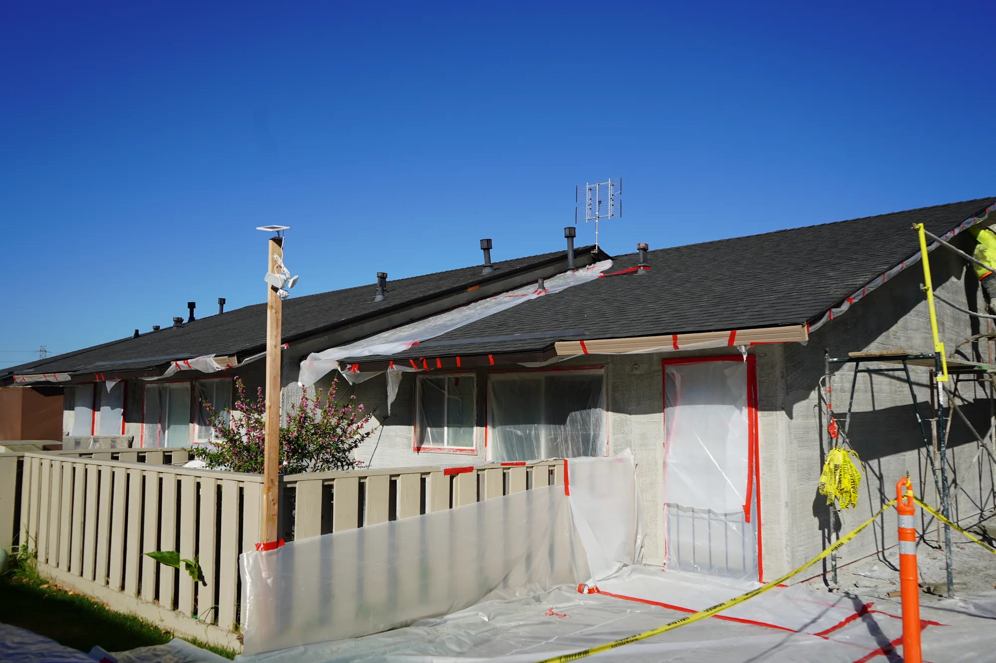 Row of Mayfair apartment units with windows and doors masked for stucco application
