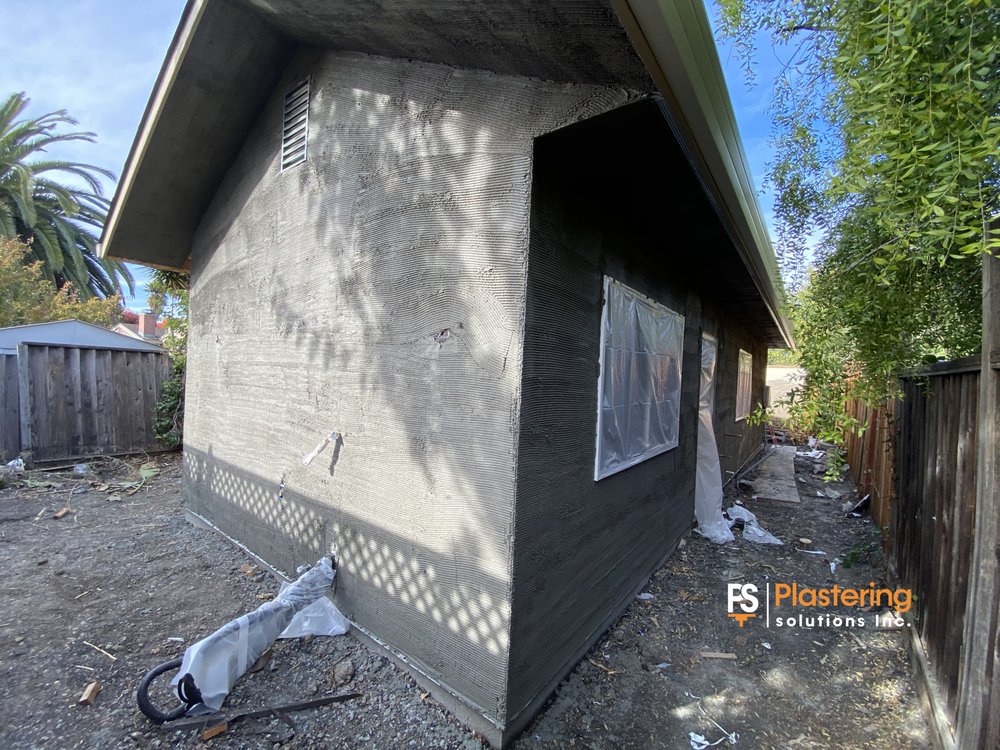 Scratch coat applied to the new structure with windows masked