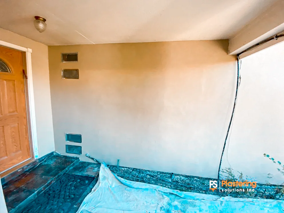 Covered entry wall with the completed smooth acrylic finish