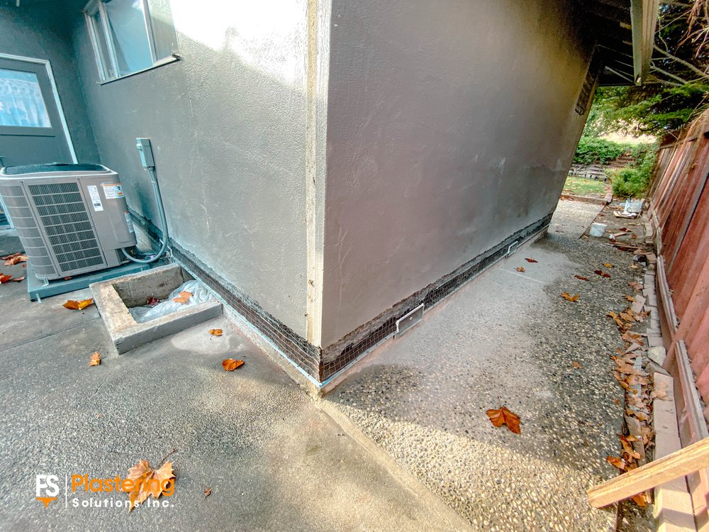 Wire lath installed along the base of the walls at a home corner