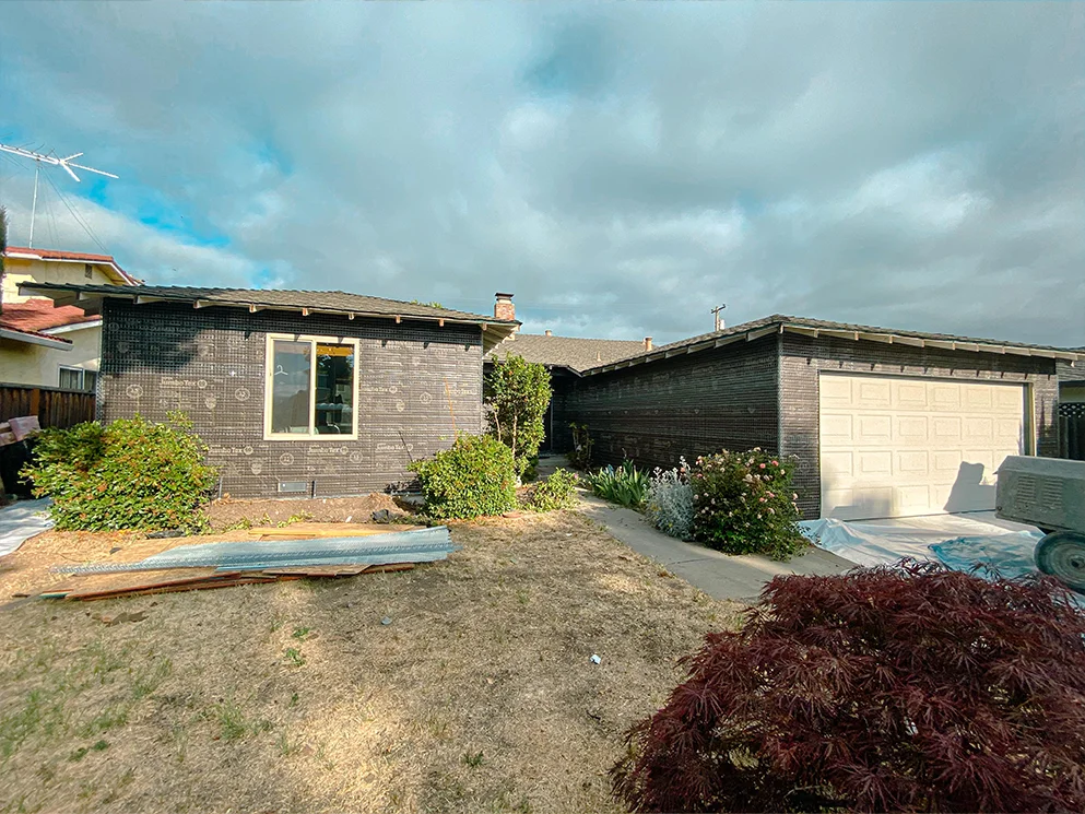 Front of the home wrapped in building paper and metal lath