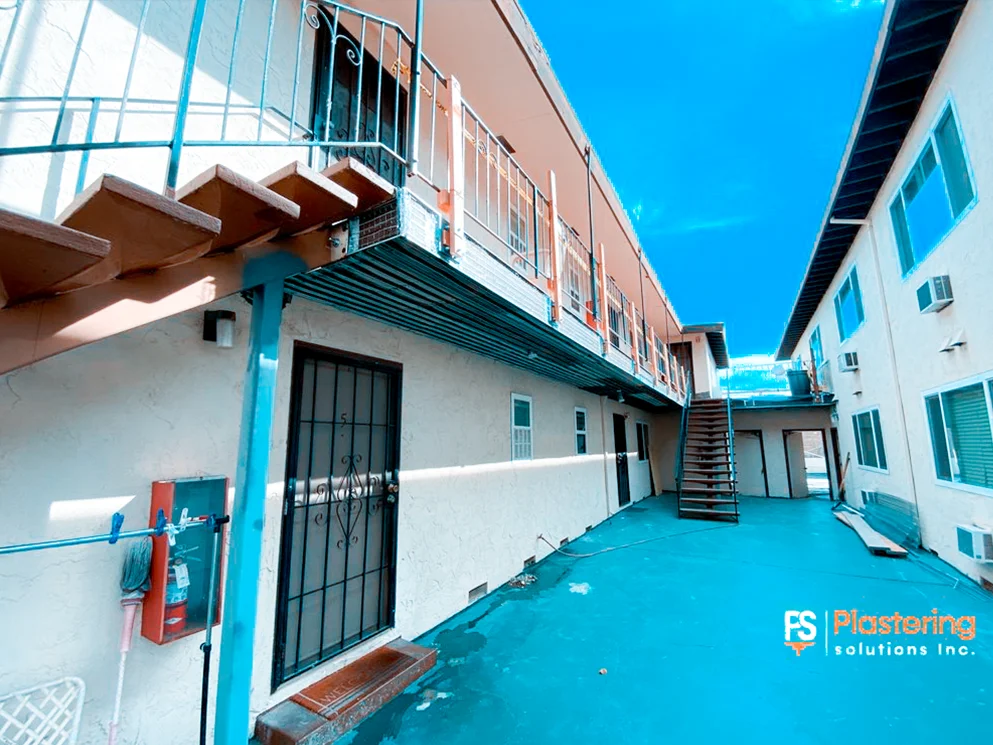 Apartment courtyard with walkways, stairs, and protected ground surface