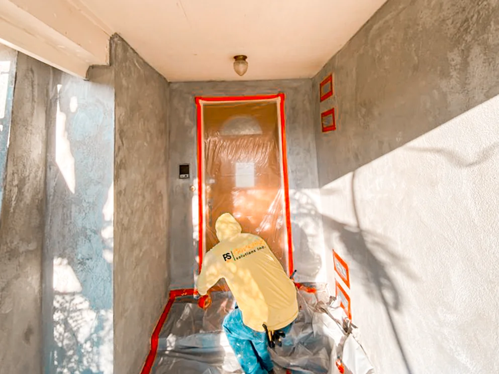 Crew member masking the entry before the finish coat