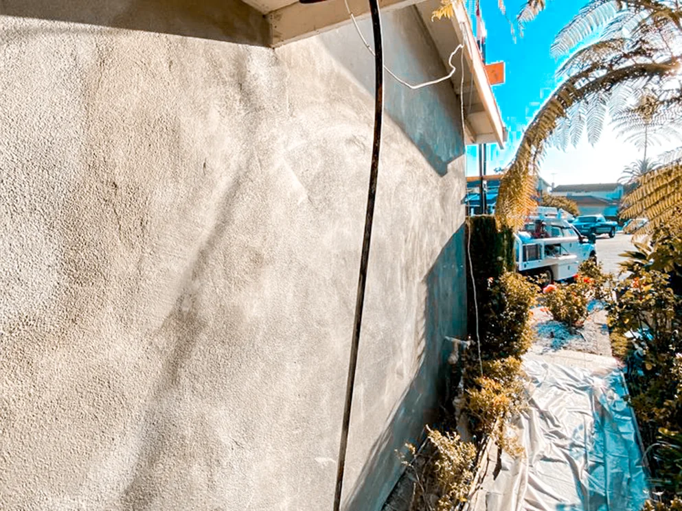 Close view of the stucco wall surface before the smooth acrylic finish