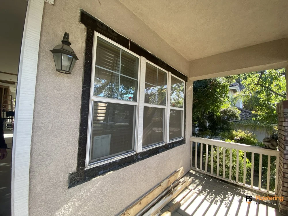 Installed windows with the surrounding stucco opened for patch back work