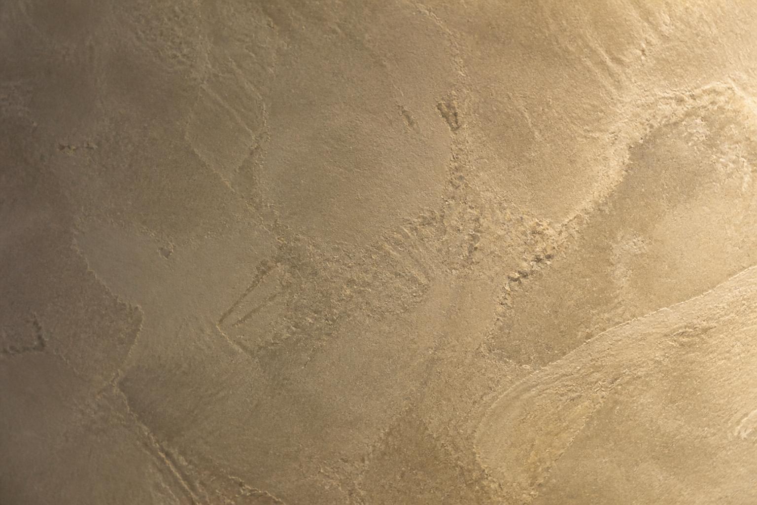 Close view of a honed marmorino wall showing its stone like texture and marble dust grain