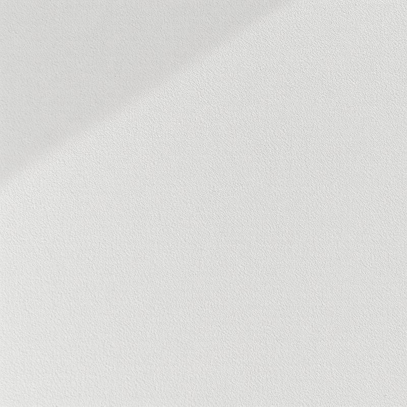 Close view of a smooth troweled wall finish with soft raking light across it