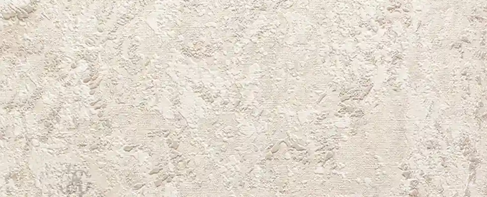 Close-up of a light cream traditional stucco finish with a hand-troweled texture