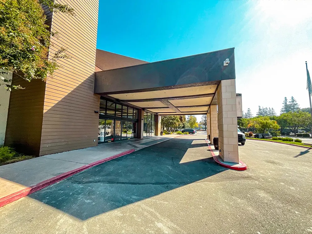 Completed commercial entrance with the repaired canopy viewed from the parking lot
