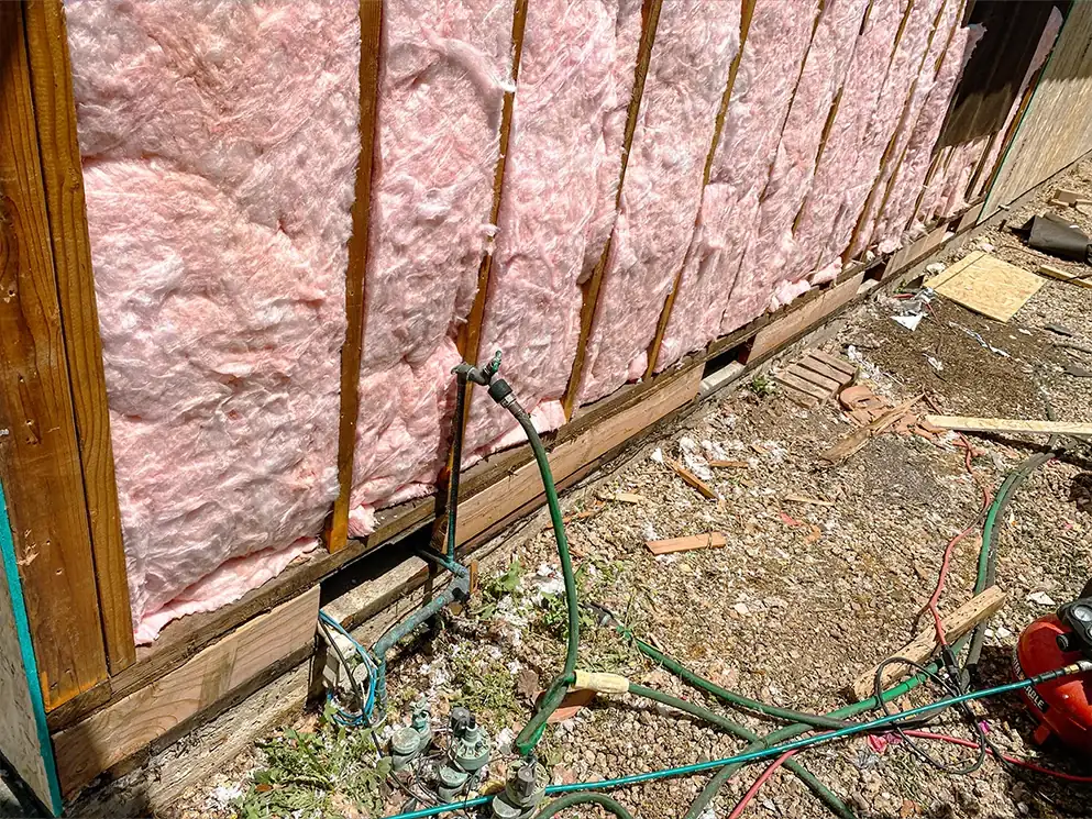 Insulation installed between studs along the lower wall