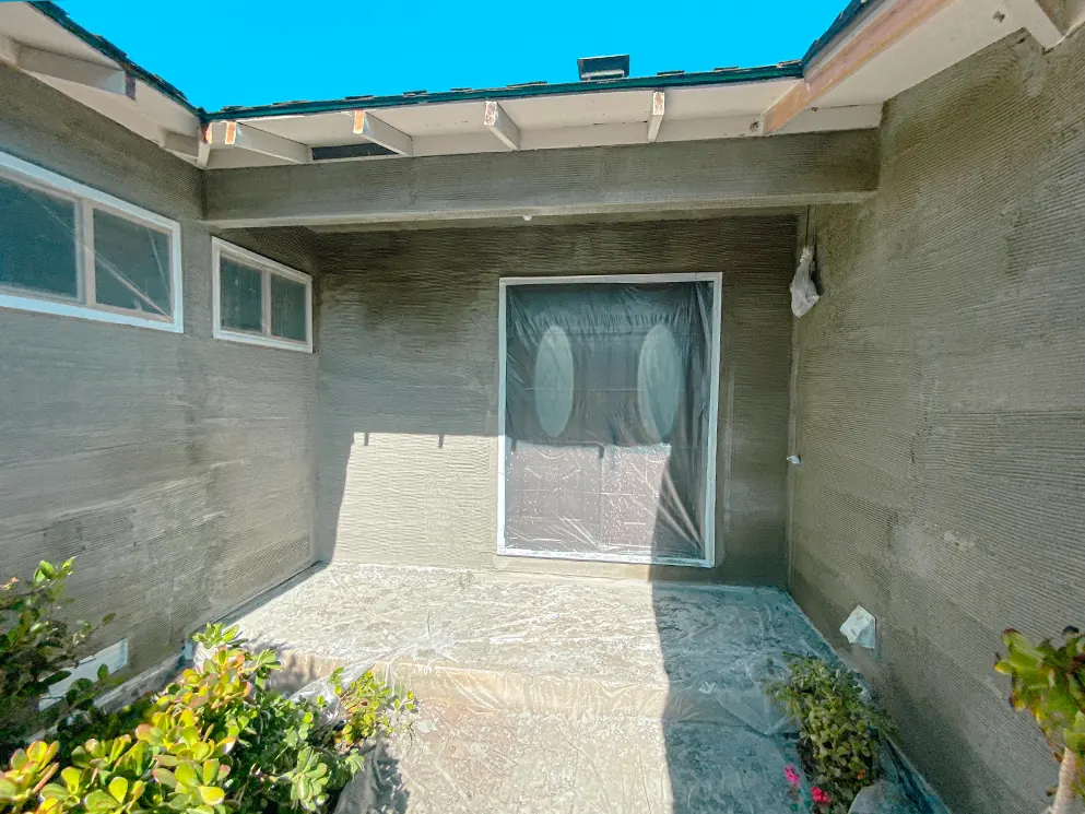 Front entry with the scratch coat applied and the doors masked