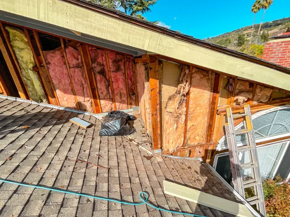 Upper walls opened to the framing and insulation above the roofline