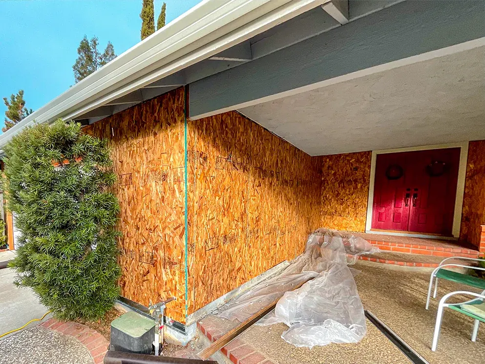 New structural sheathing installed along the front wall and entry