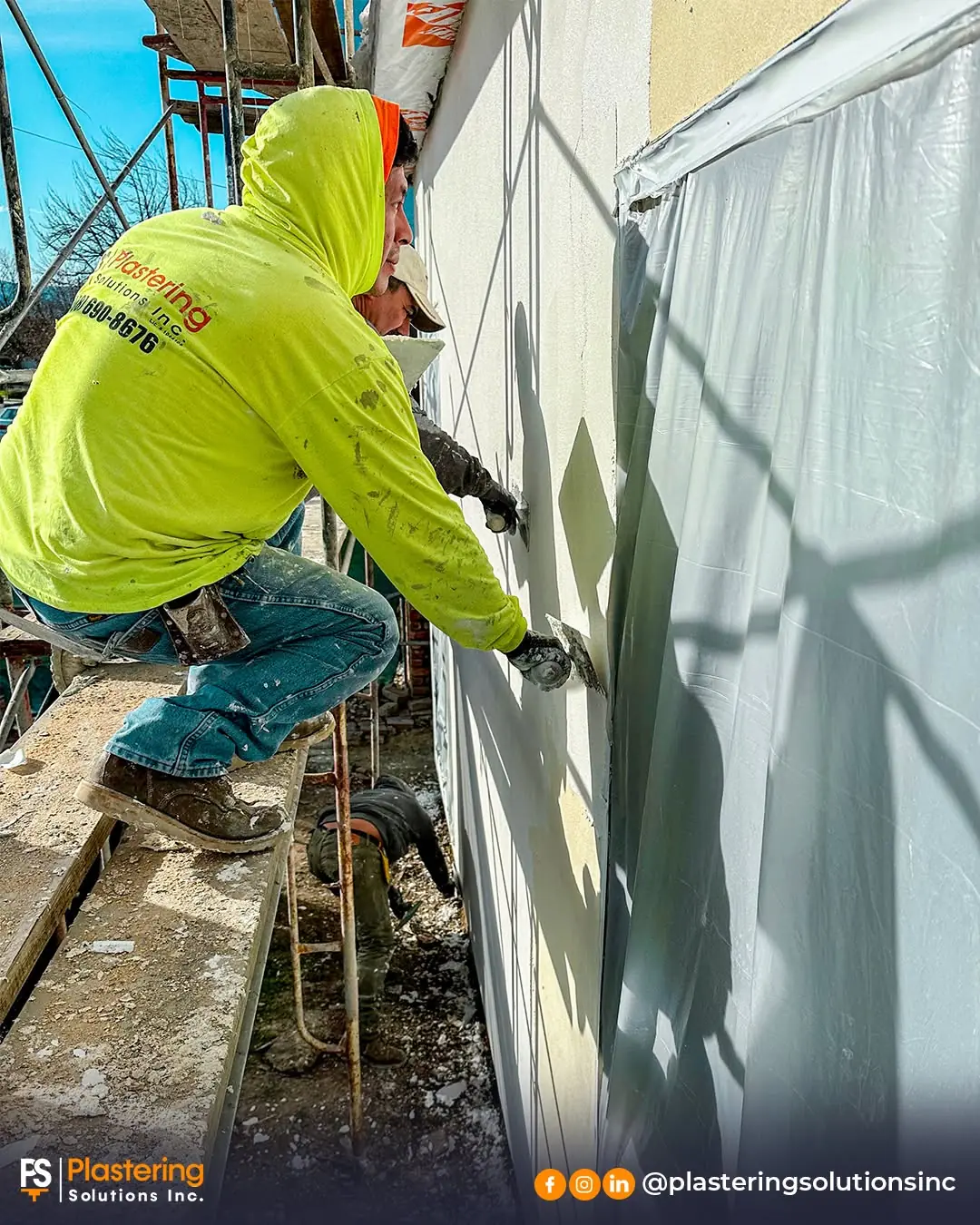 Plastering Solutions crew member applying stucco beside a protected window on a San Jose project