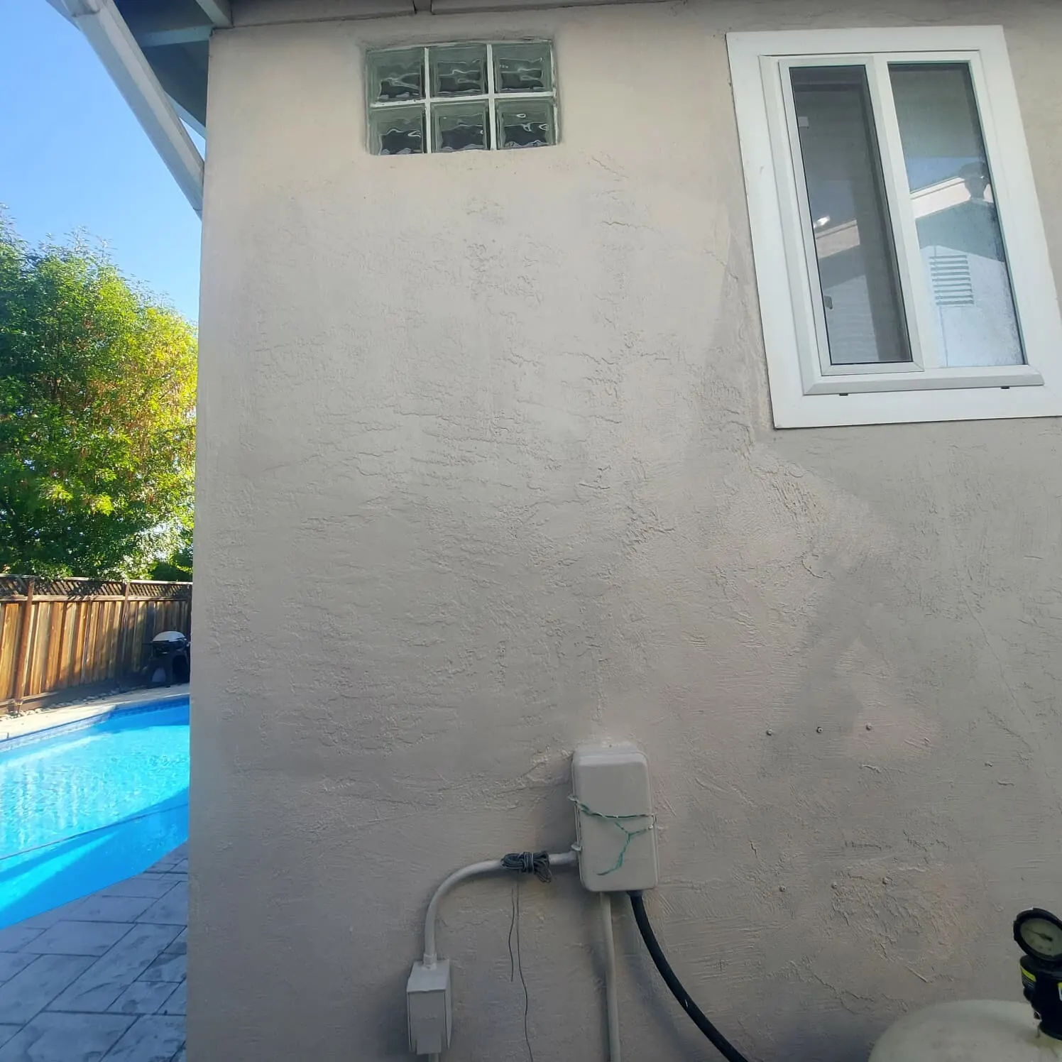 Completed stucco repair blended into the texture and color of the surrounding wall