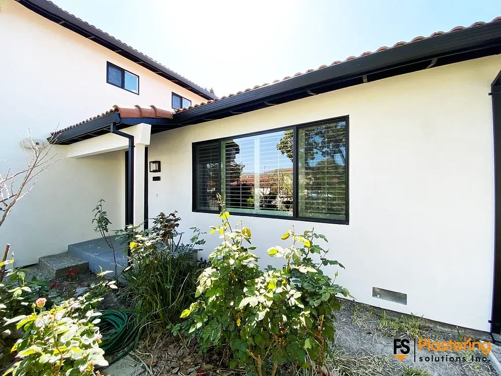 Finished smooth stucco front elevation with landscaping and tile roof